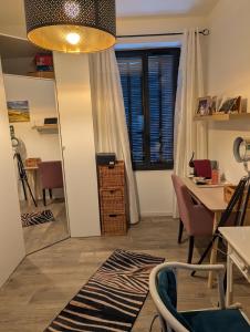 a room with a table and chairs and a window at Chambre ELENA in La Crau