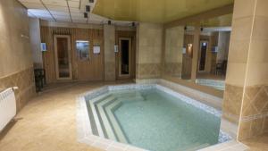 a large swimming pool in a building with mirrors at Top 10 3BR2BH Jacuzzi Free Parking in Sofia