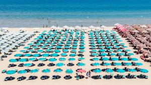 a large group of chairs and umbrellas on a beach at Hotel President in Vasto +31 photos