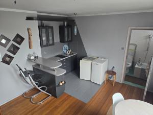 a kitchen with a sink and a refrigerator at Duplex U Marzeny in Ostróda +15 photos