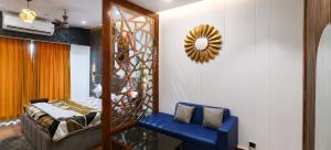 a bedroom with a bed and a chair and a mirror at Darshana Studios#Galaxyblue sapphire#Stylish in Ghaziabad