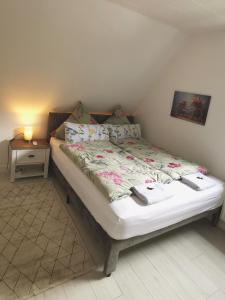 a bed in a room with a nightstand and a bed sidx sidx at Ruhe am Walde in Meschede