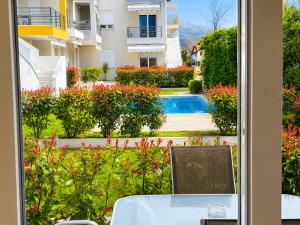 a room with a table and a view of a garden at Pool Access Danai 15,1 in Ofrínion