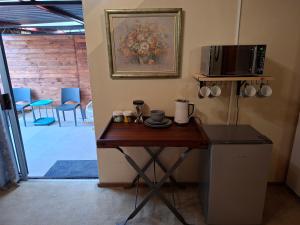 a small table in a room with a microwave at De Windmolen in Centurion