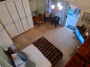 an overhead view of a bedroom with a bed and a dining room at De Windmolen in Centurion