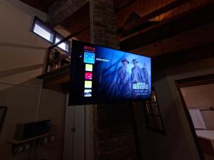 a flat screen tv hanging on a wall at De Windmolen in Centurion
