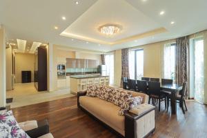 a living room with a couch and a dining room at Spacious Sololaki 2BR with Balcony - by Wehost in Tbilisi City +37 photos