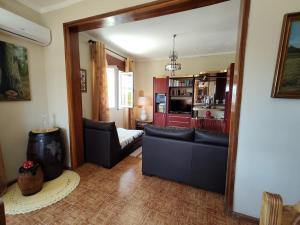 a living room with two chairs and a mirror at Casa Os Maias - Jardim, terraço e espaço para 10 pessoas in Mirandela