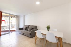 a living room with a couch and a table and chairs at Rentalmar Sol de España - Mas d'en Gran in Cambrils