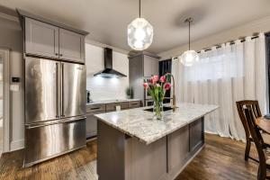 a kitchen with a stainless steel refrigerator and a counter at Modern Spacious 3 bed 3 12 bath suites in Dallas