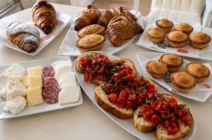 a table with different types of bread and pastries at B&B I like salento in Uggiano la Chiesa