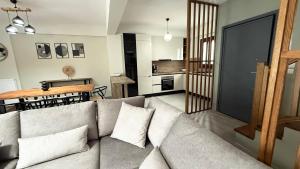 a living room with a couch and a dining room at Athos Villas in Ouranoupoli