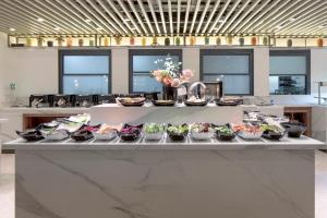 a buffet line with bowls of food on it at Sura Concept Hotel in Istanbul