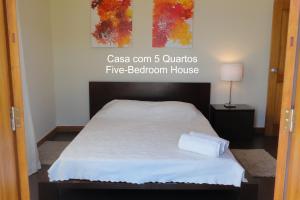 a bed in a room with a sqor sqor at First Balcony - Porto Santo in Porto Santo