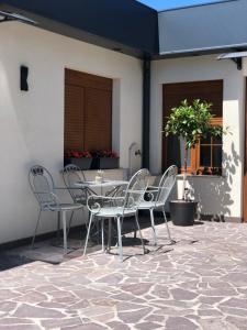 a table and chairs sitting on a patio at Prestige Apartment & Studio Apartment in Đakovo