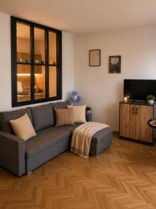 a living room with a couch and a flat screen tv at Studio Słowackiego in Września