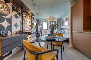 a kitchen and dining room with a table and chairs at Loft 23 Boutique Hotel in St. Julianʼs
