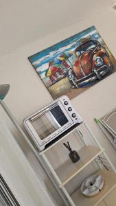 a painting of a microwave on top of a refrigerator at La Rose des Sables - face à la mer in Frontignan
