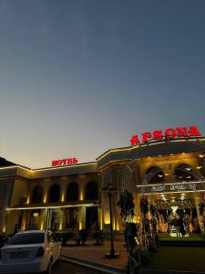 a store with a car parked in front of it at Afsona Hotel in Bukhara