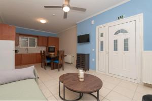 a living room with a white door and a table at The old inn in Laganas