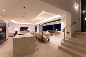 a living room with a kitchen and a dining room at Sea Gardens Villa in Nerja
