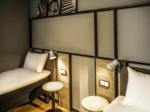 a room with a bed and a chair and a table at ibis Wels in Wels