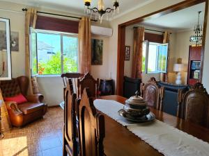 a dining room with a table and chairs at Casa Os Maias - Jardim, terraço e espaço para 10 pessoas in Mirandela