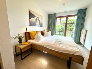 a large bed in a room with a window at Oewern Diek App 02 in Wustrow