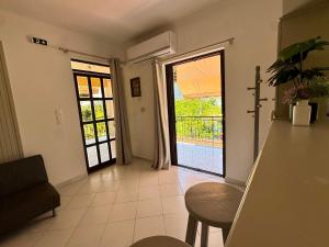 a living room with a door leading to a patio at Koala Place in Vasiliki