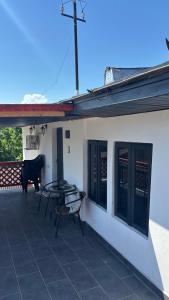 a patio with a table and a bench on a house at Gemini house in Măcin