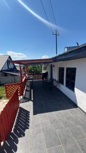 a patio of a house with a red roof at Gemini house in Măcin