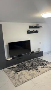 a living room with a flat screen tv on a wall at Gemini house in Măcin