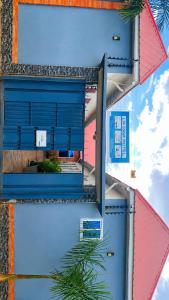 two pictures of a building with a blue door at La casa Motel in Kahama