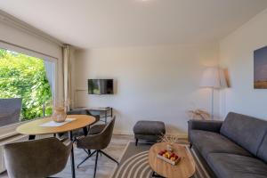 a living room with a couch and a table at Boddenweite 1 in Born