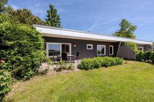 a gray house with a lawn in front of it at Boddenweite 1 in Born