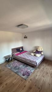 a bedroom with a bed with a teddy bear sitting on it at Gemini house in Măcin