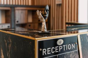 a statue on top of a box with a sign at Marine Point Hotel & Antalya in Antalya