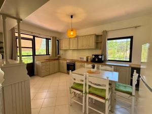 a kitchen with a table and chairs in it at Koala Place in Vasiliki