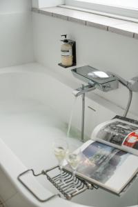 a table with a book and glasses on it at Bonnie's Beachhouse - villa aan zee in De Panne +16 photos