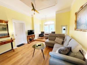 a living room with a couch and a table at Villa Stolle, Ferienwohnung in Schneverdingen