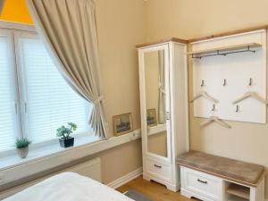 a bedroom with a large mirror and a window at Villa Stolle, Ferienwohnung in Schneverdingen