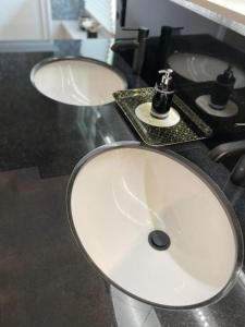 two white sinks in a bathroom with a counter at Villa Stolle, Ferienwohnung in Schneverdingen +12 photos