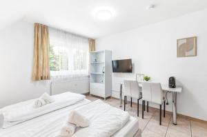 a bedroom with two beds and a table and chairs at Gasthaus Hirschkeller in Göppingen