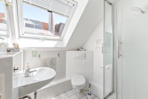 a bathroom with a sink toilet and a window at Gasthaus Hirschkeller in Göppingen +59 photos