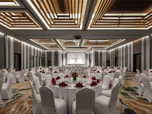 a banquet hall with white tables and white chairs at Pullman Phu Quoc Beach Resort in Phú Quốc +115 photos