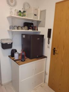 a tv sitting on top of a cabinet in a room at Souterrainwohnung in Viernheim