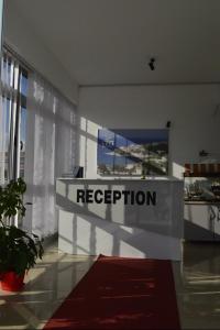 a reception desk with a sign in a room at Leli Apartments in Ulcinj