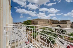 a balcony with white railings on a building at Loft 23 Boutique Hotel in St. Julianʼs