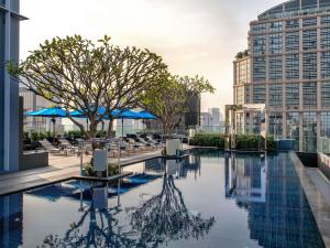 a swimming pool on the roof of a building at Mercure Bangkok Sukhumvit 24 in Bangkok +54 photos