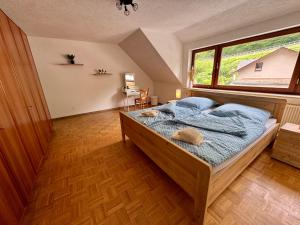 a bedroom with a bed and a large window at Ferienhaus zum Wasserfall in Bernkastel-Kues